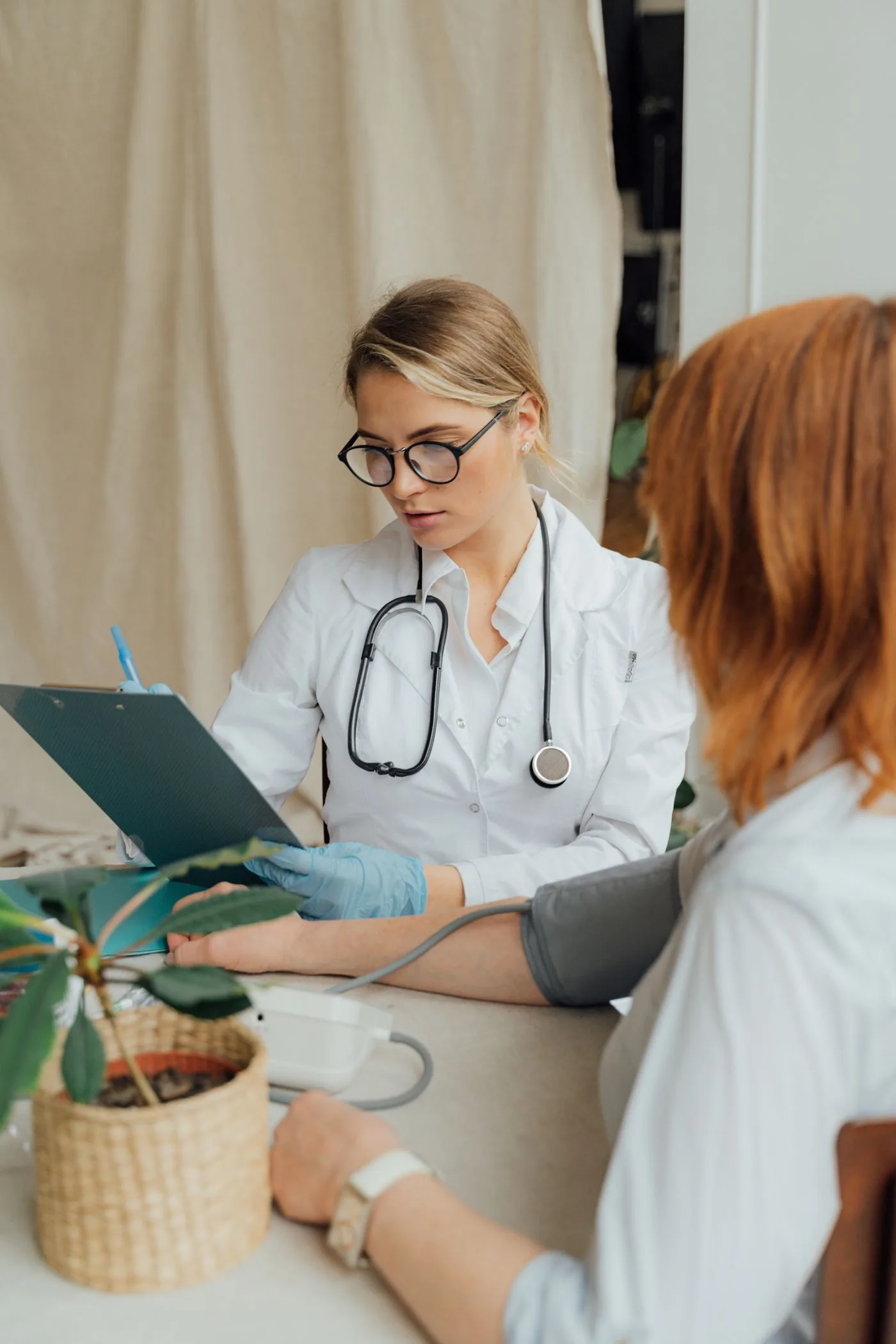 A doctor checking a patient’s blood pressure