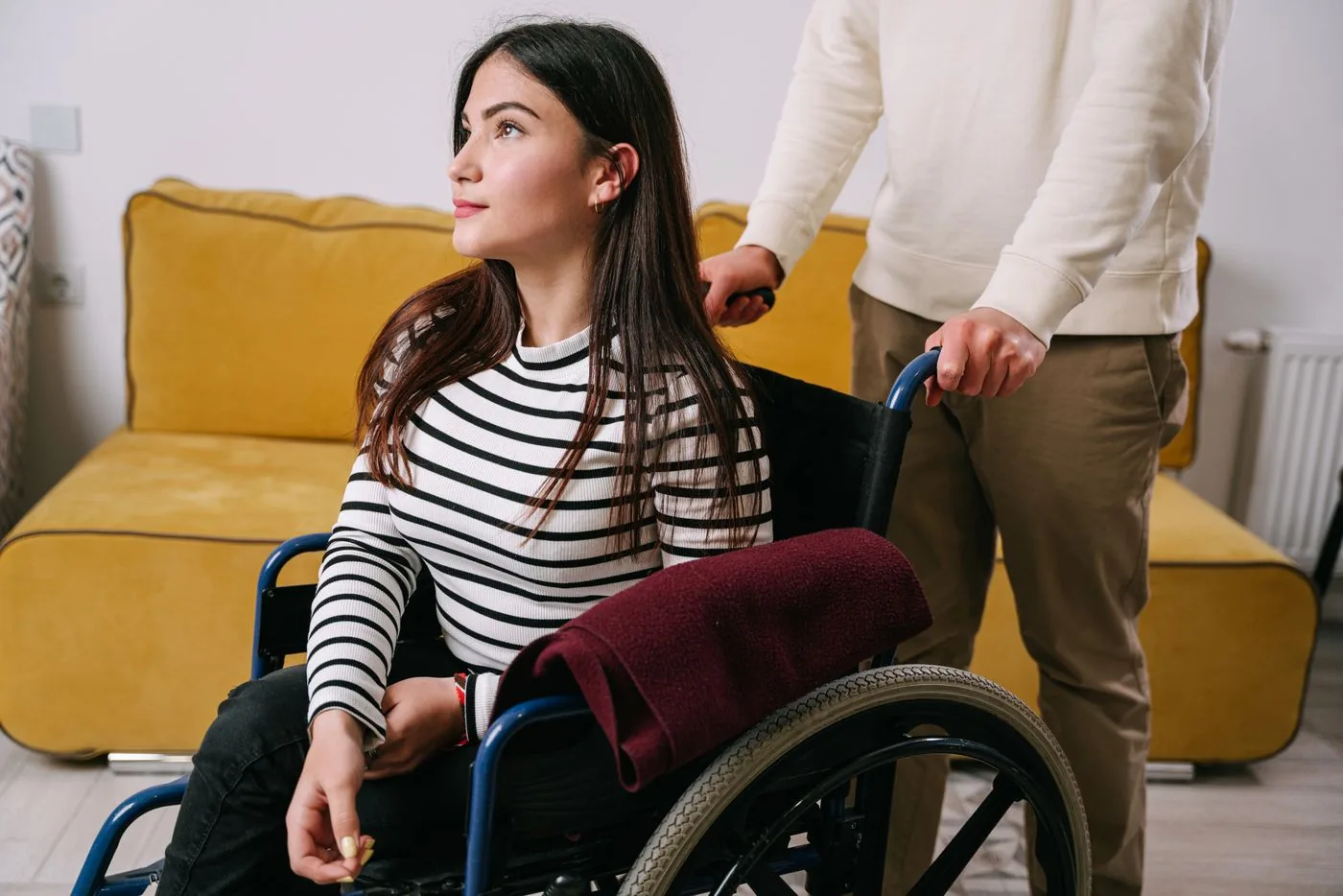 A wheelchair user receiving support at home