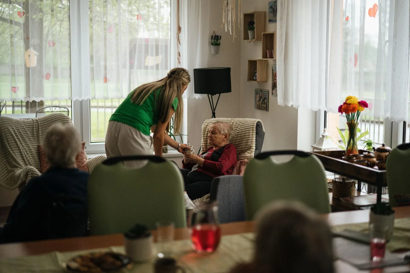 A caregiver supporting older residents in a nursing home